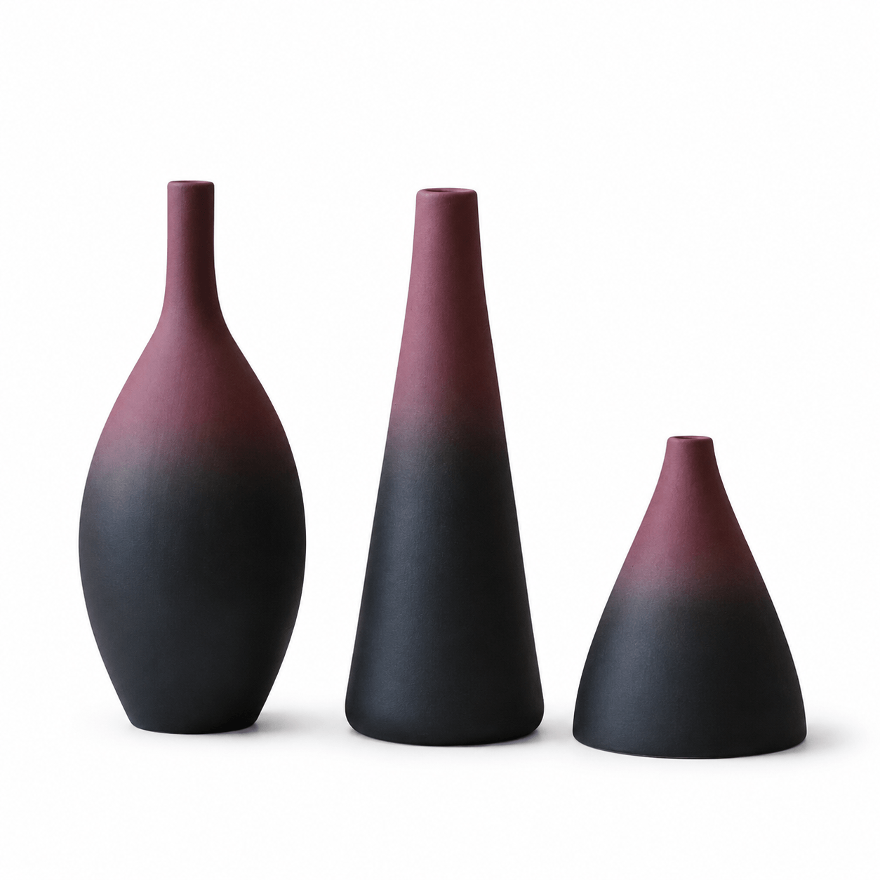 Three-piece ceramic vase set with tall and cone shapes on a white background