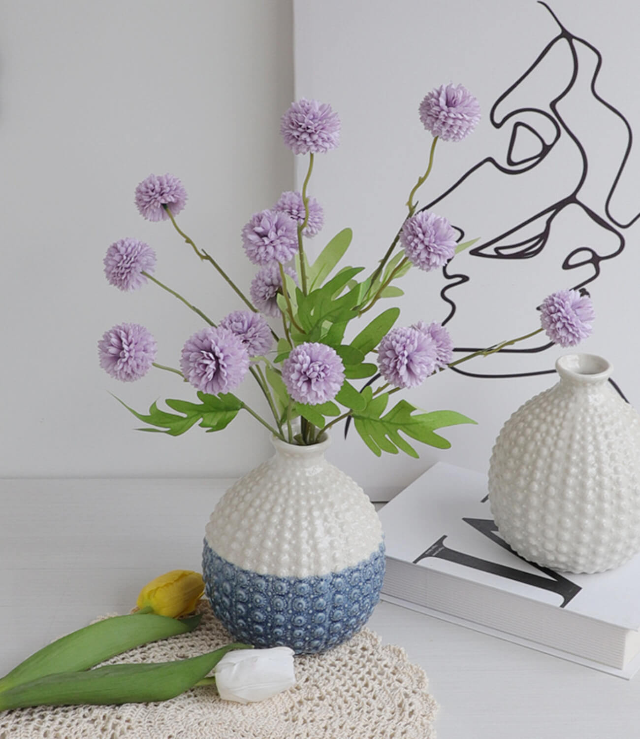 Petals unfurl in the artistic ceramic vase, like a beautiful melody, filling the home with a tranquil atmosphere.