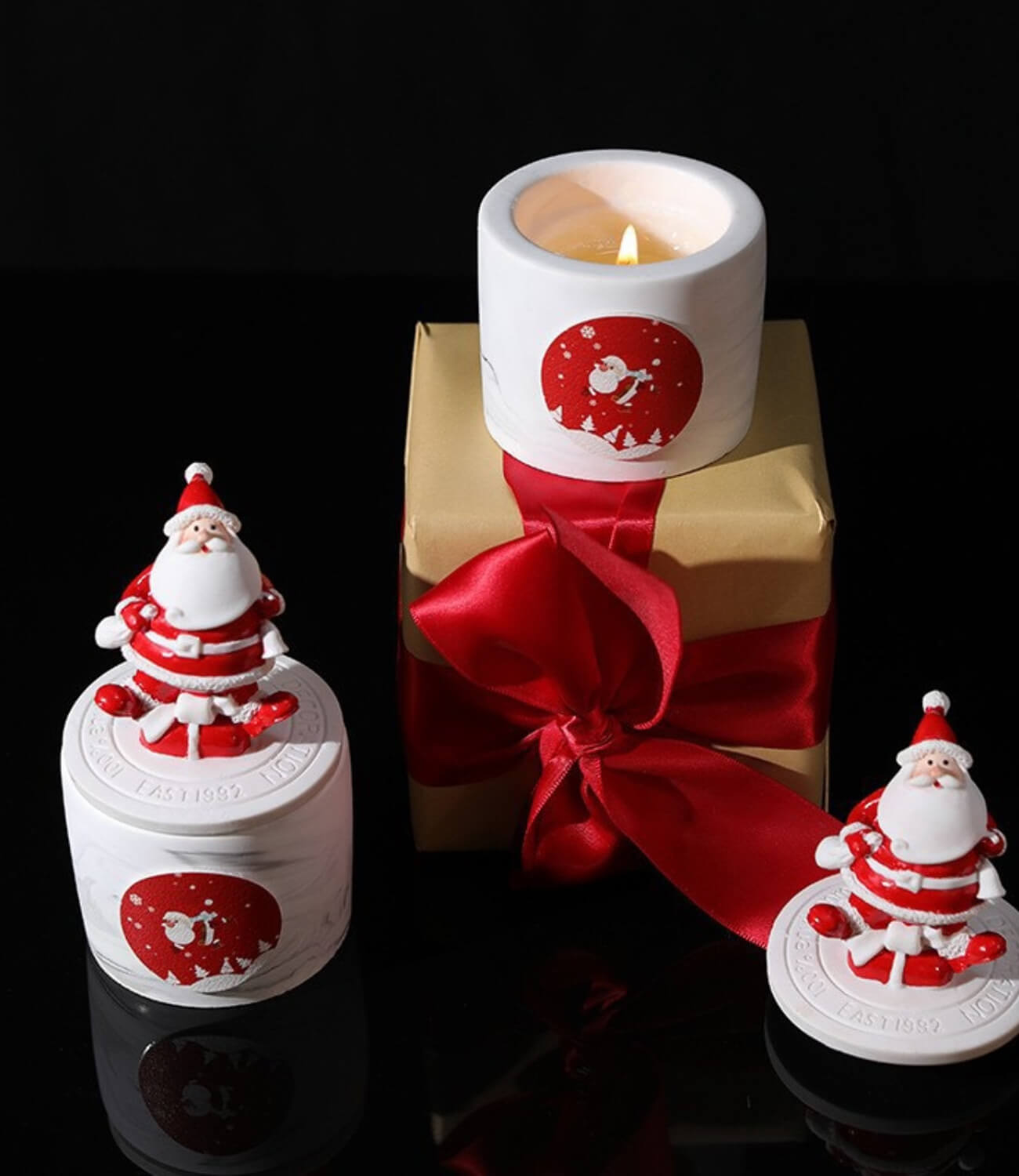 Elegant white Christmas candles adorned with golden ornaments.