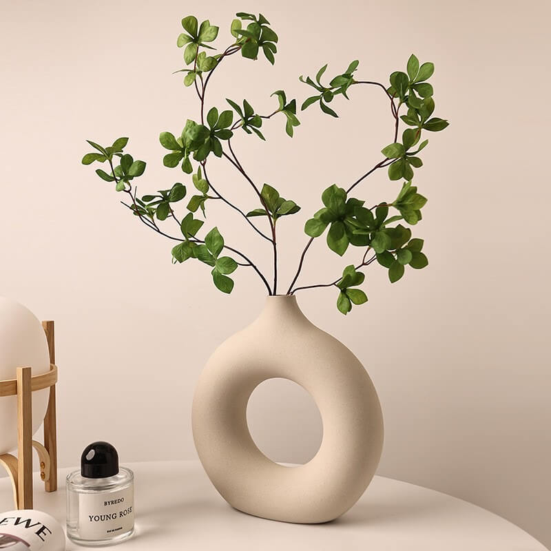  Large-sized ceramic vase paired with a single delicate leafy tree decoration.