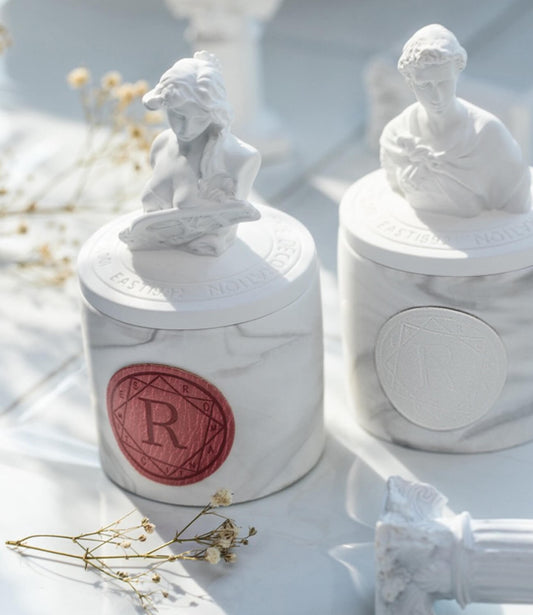 A beautifully packaged Roman-style aromatherapy candle.