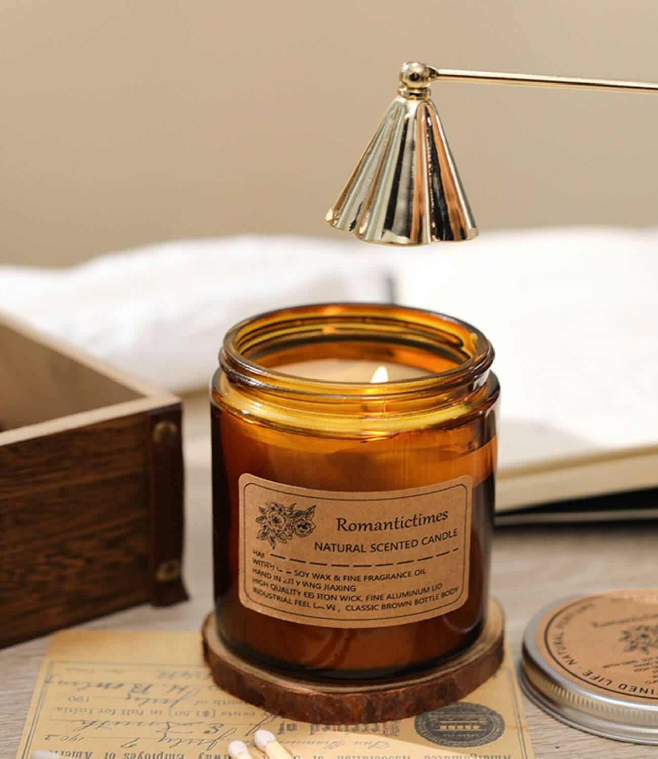 A scented candle with the delicate fragrance of bluebells fills the air, casting a gentle glow on an exquisite candle holder.