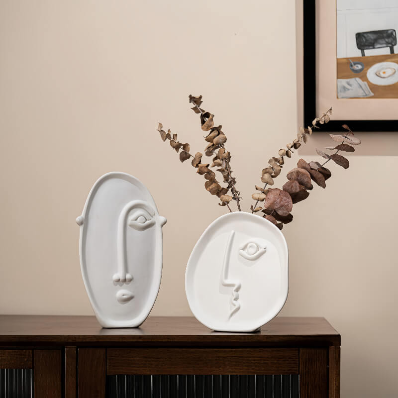 Single face and large long face vases with flower arrangemen