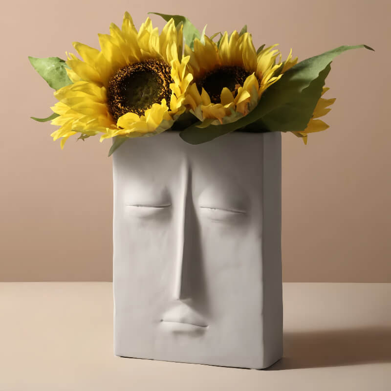 Large square face vase with flower arrangement