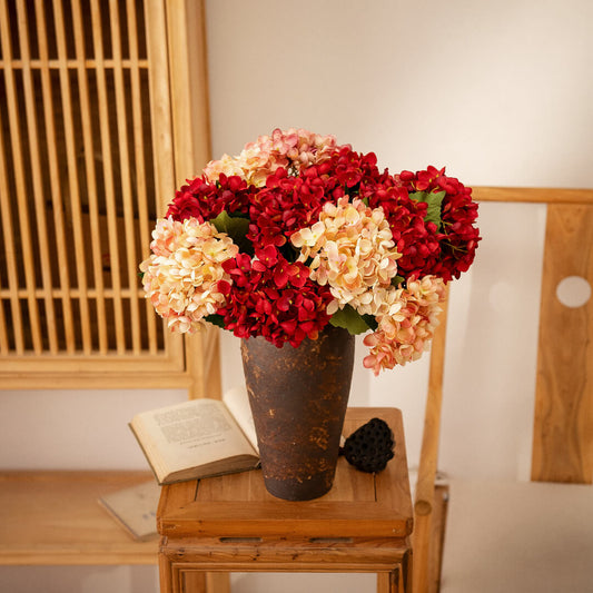 Hydrangea arrangement in vase, vibrant colors.