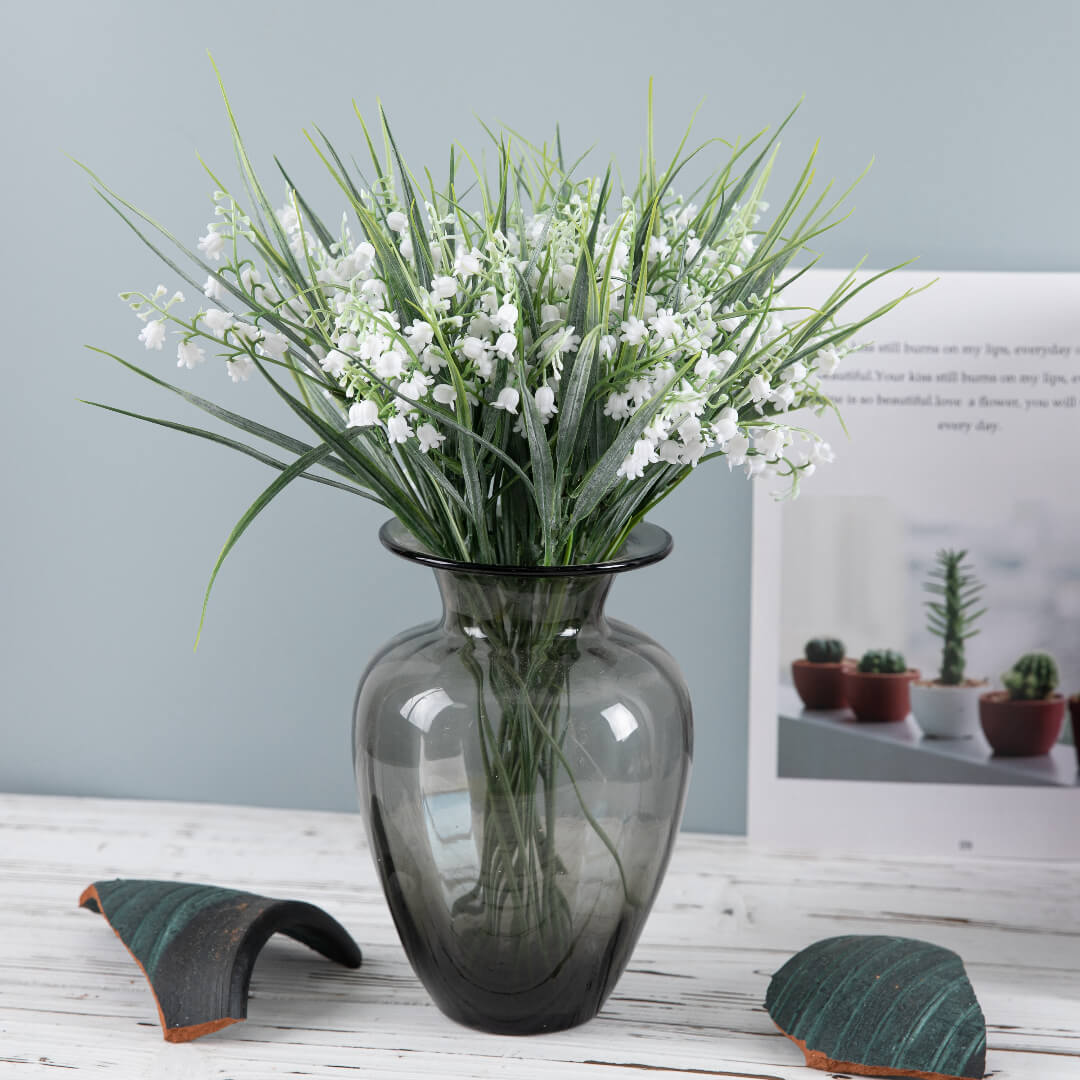 Close-up of Wind Chime Grass showcasing its fresh white flowers and delicate plumes.