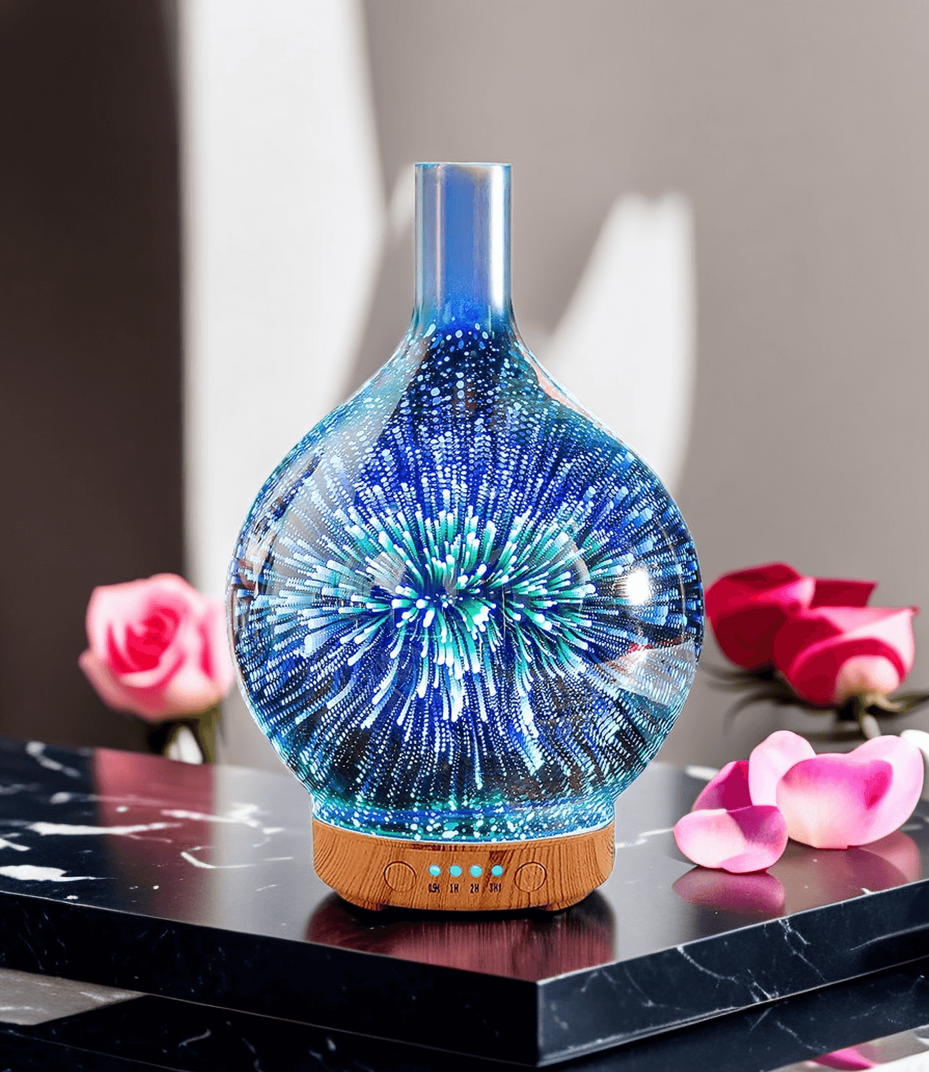 Blue glass firework aroma diffuser with glowing light on a marble table with pink roses