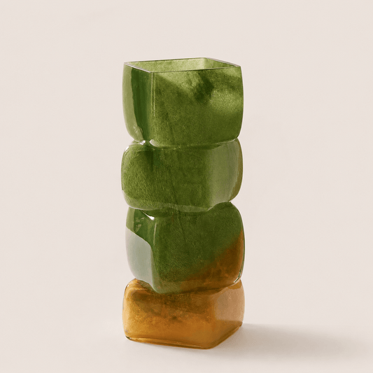 Olive amber sculptural hand-blown glass vase with stacked geometric form on a clean neutral background.