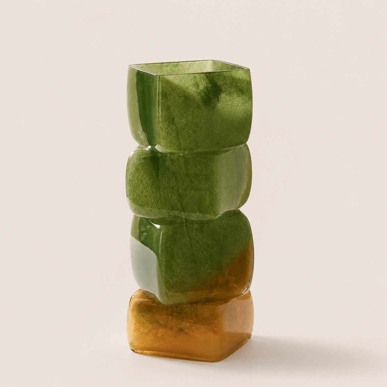 Olive amber sculptural hand-blown glass vase with stacked geometric form on a clean neutral background.