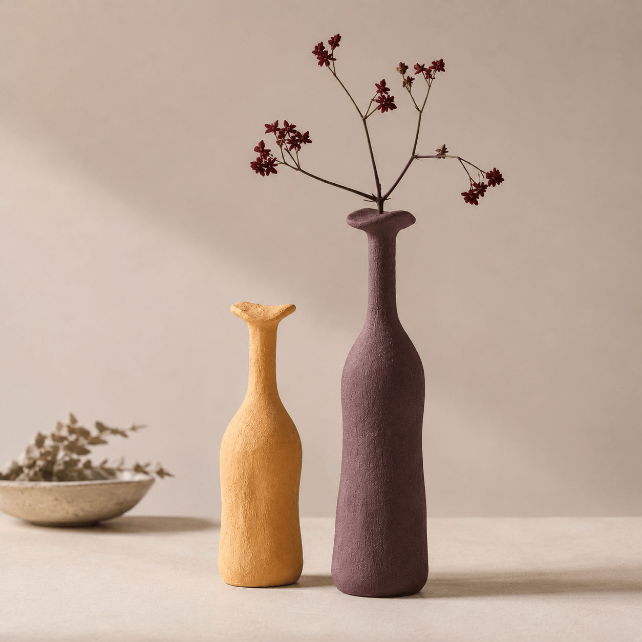 Apricot Yellow and Deep Purple Gray narrow-neck ceramic vases styled together with flowers.
