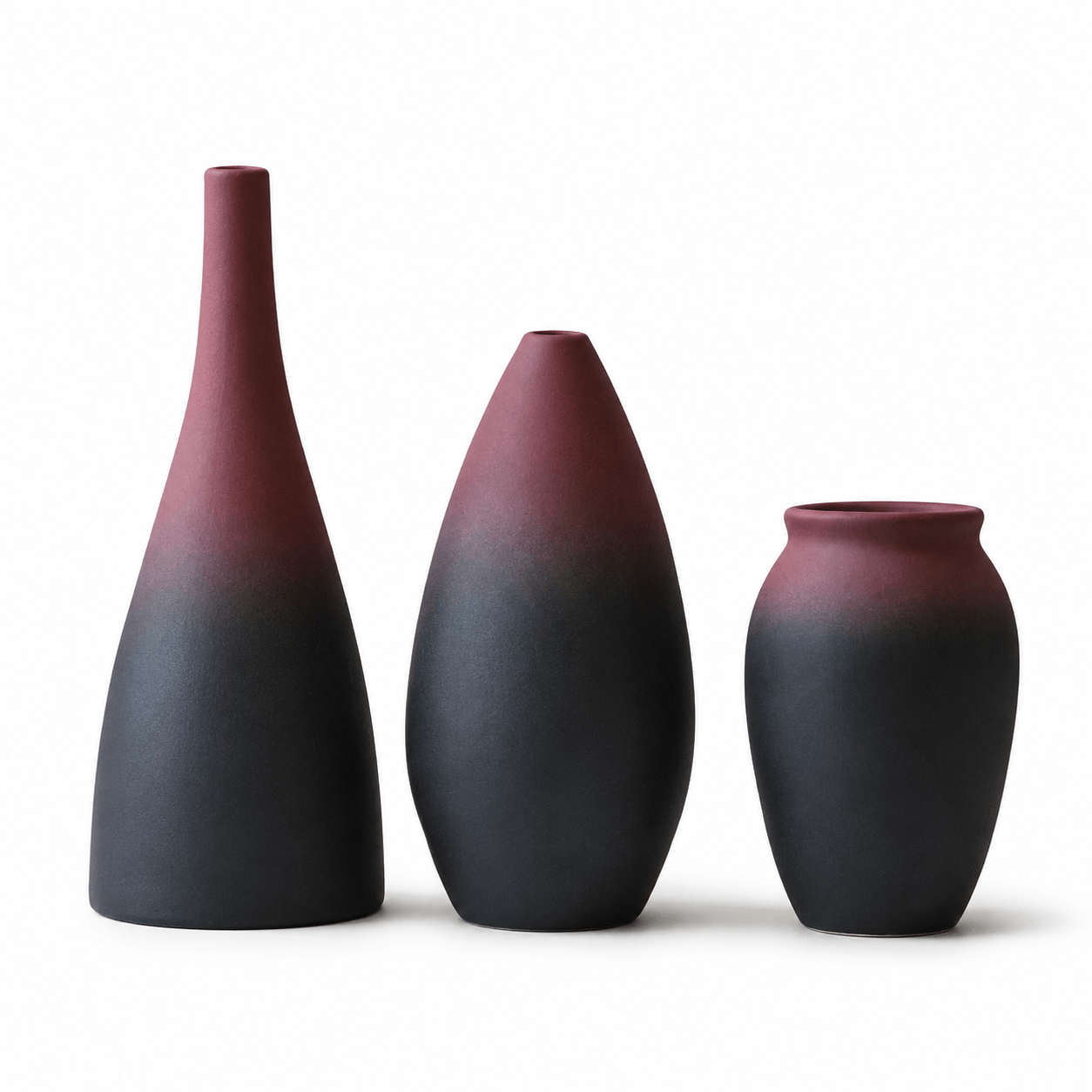  Three-piece mauve and charcoal ceramic vase set on a white background