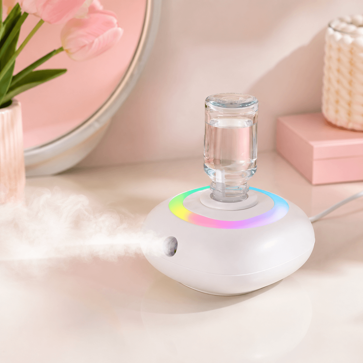 Close-up of a rainbow diffuser on a pink vanity with gentle mist
