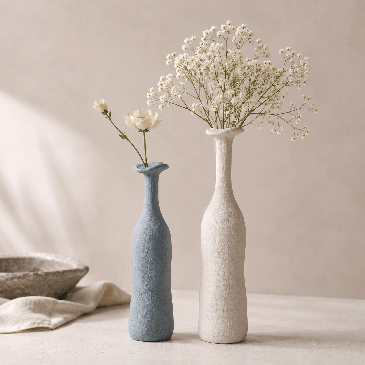 Aqua Blue and Artistic White narrow-neck ceramic vases styled together with flowers.