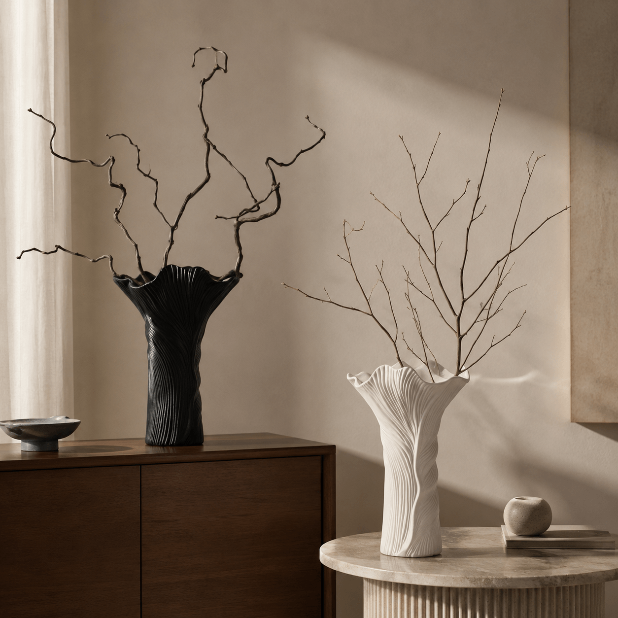 Black and white flow ceramic vases styled with branches in a modern interior