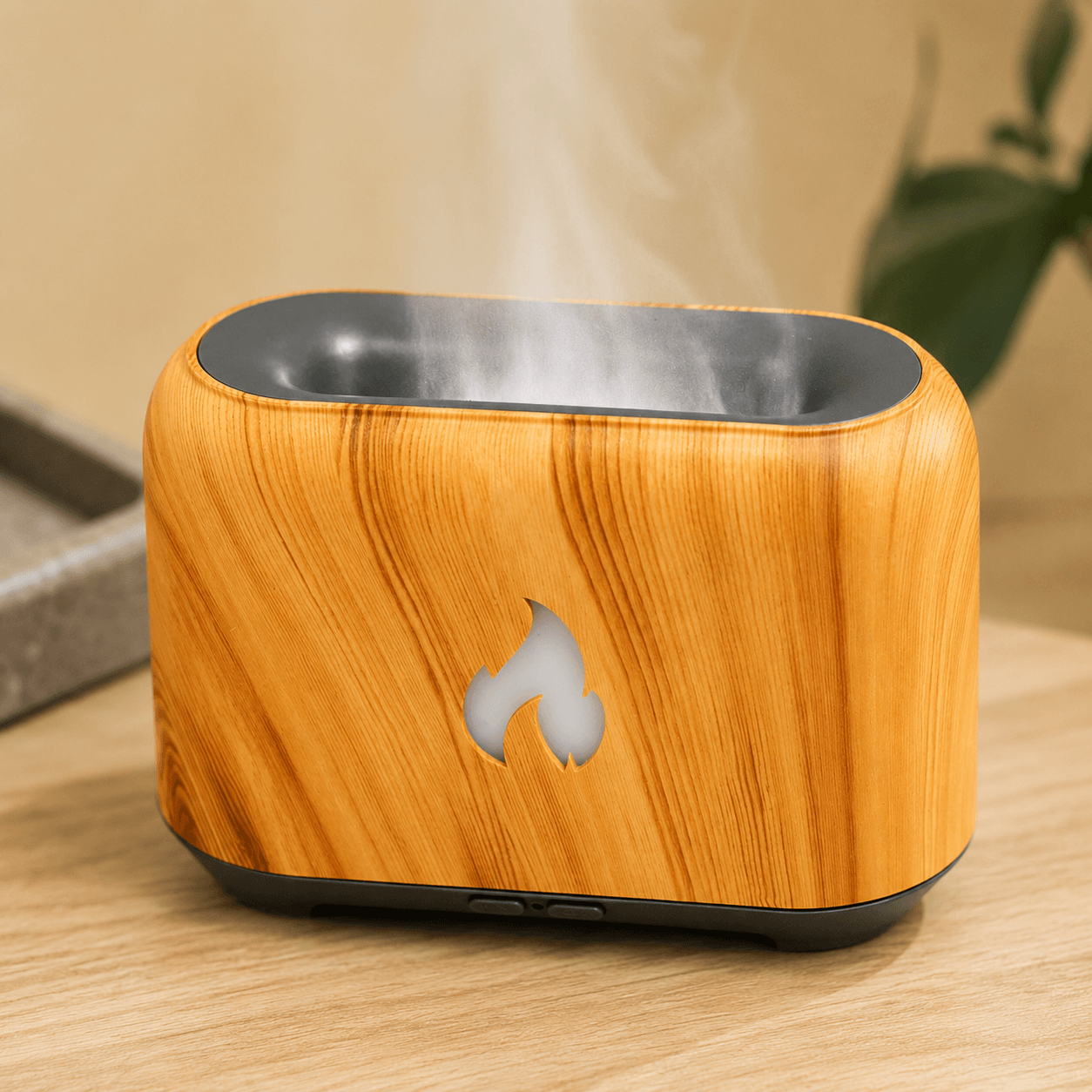 Wood grain flame aroma diffuser with soft mist on a cozy bedside table.