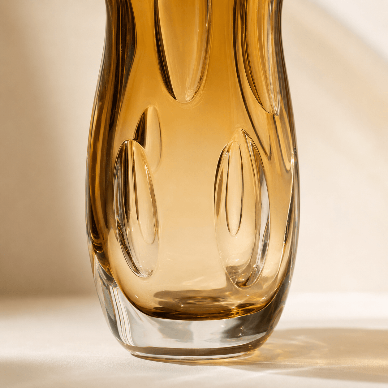 Close-up of raised inner petal details in an amber art glass vase
