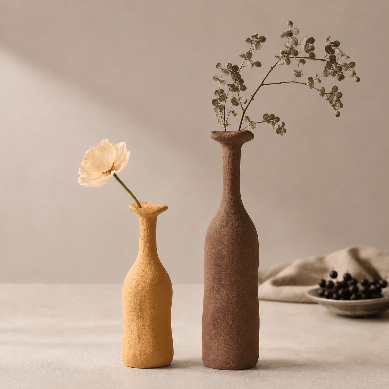 Apricot Yellow and Tea Brown narrow-neck ceramic vases styled together with flowers.
