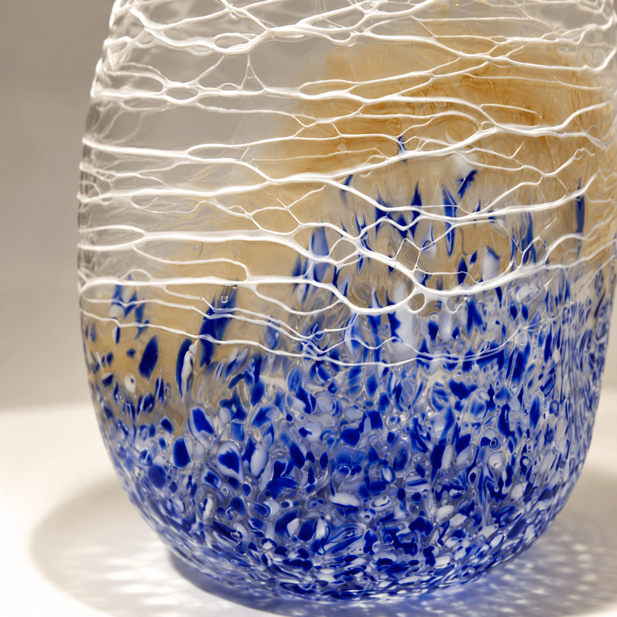 Close-up of blue purple thread-like texture on a textured art glass vase