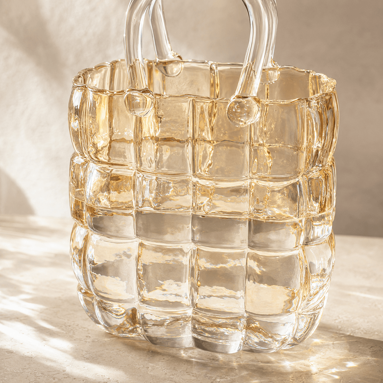 Close view of the raised basket-weave texture on the warm clear glass vase