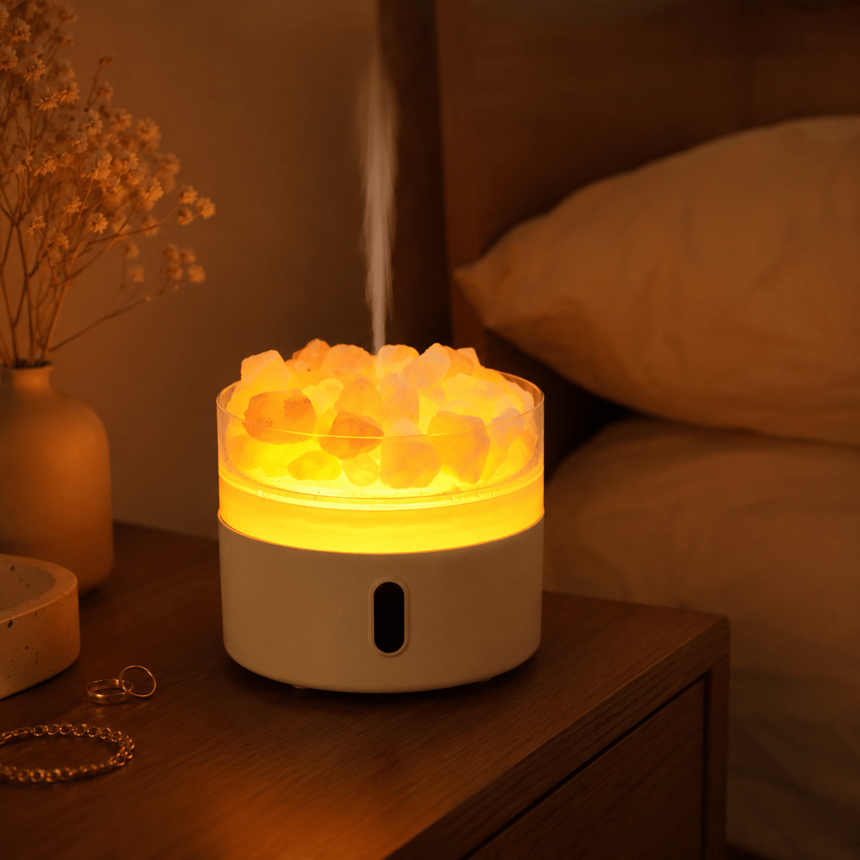 Salt stone aroma diffuser with warm amber light in a cozy bedroom at night.