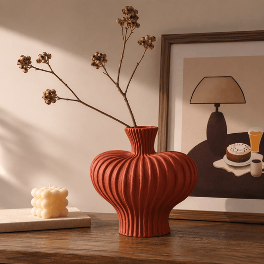 Terracotta Red ribbed ceramic vase styled with dried branches and framed wall art