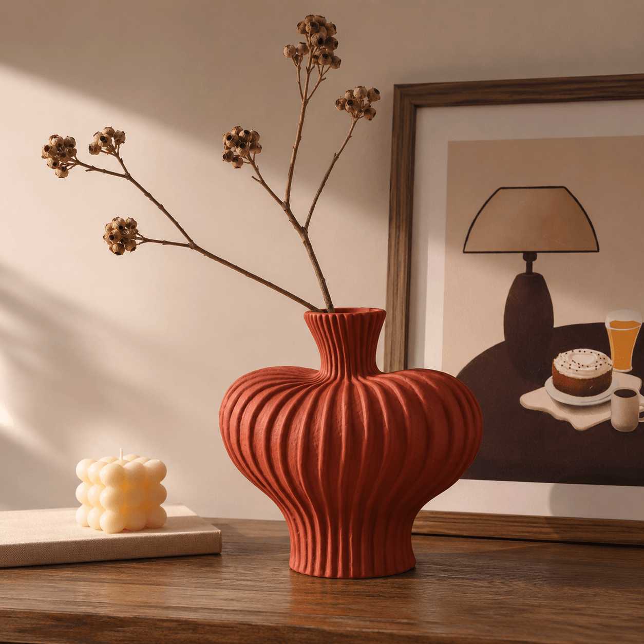 Terracotta Red ribbed ceramic vase styled with dried branches and framed wall art