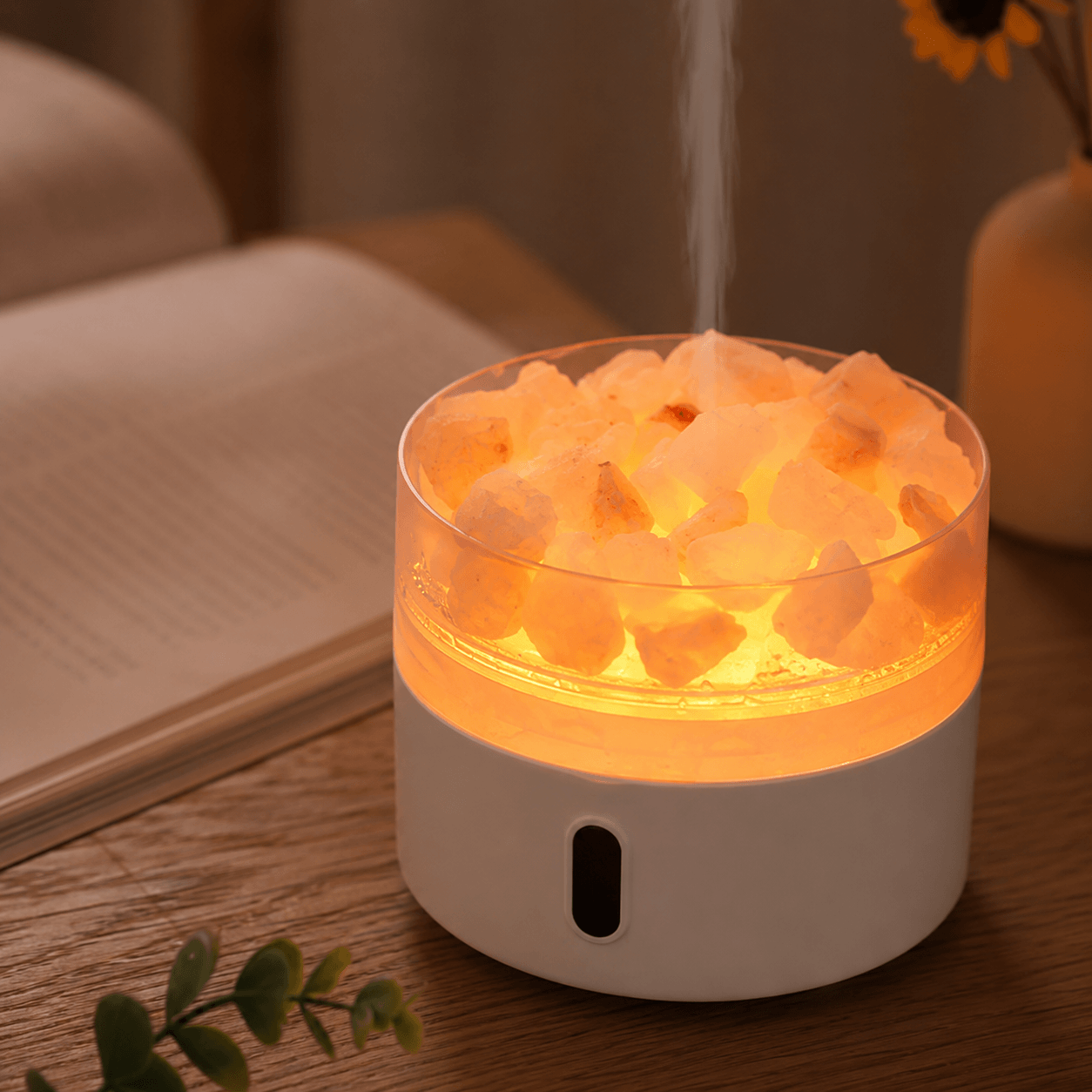 Warm salt stone diffuser with soft mist beside an open book.
