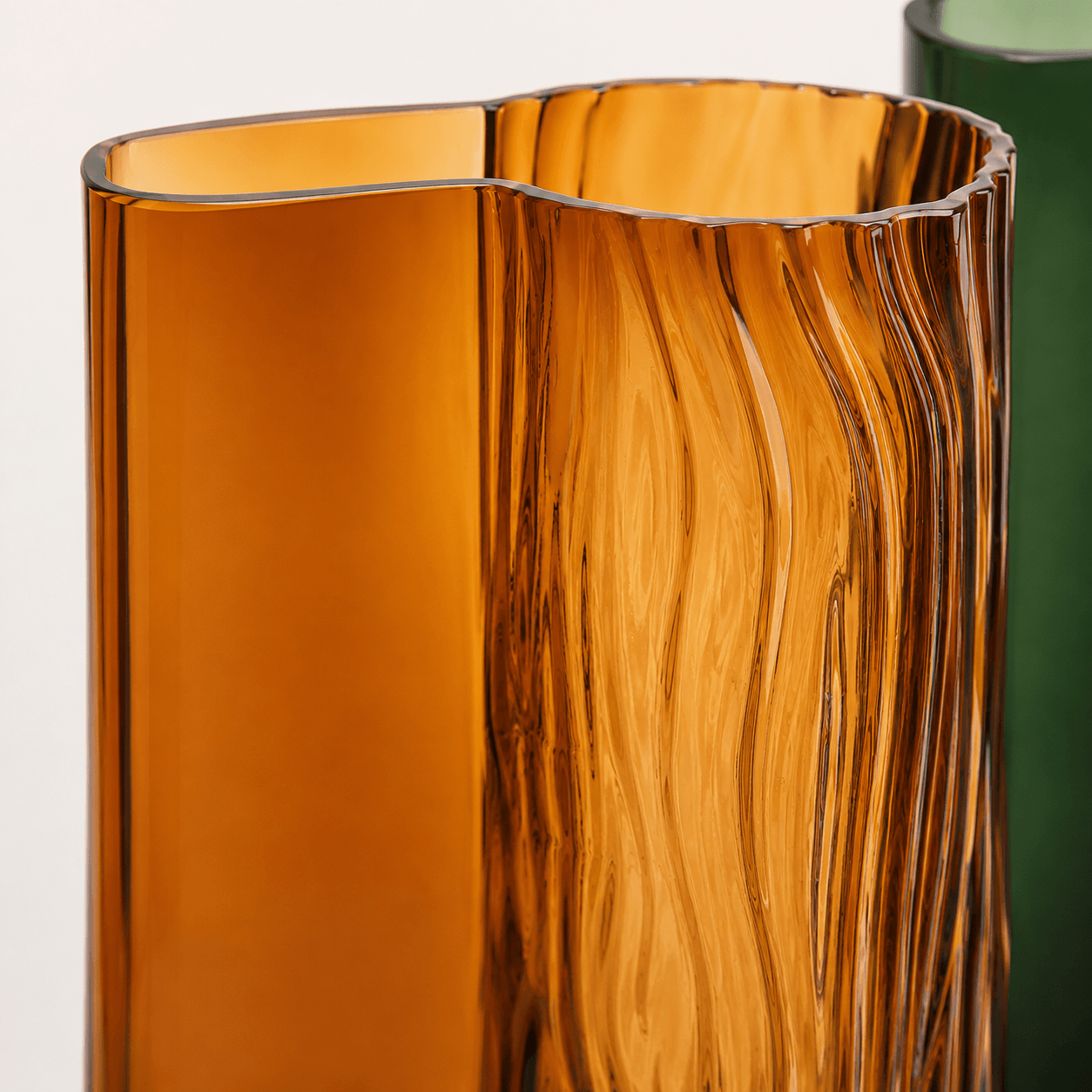 Close-up of the amber glass vase showing the rippled textured surface