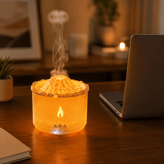 Amber crackle volcano aroma diffuser glowing on a wood desk with laptop and soft mist.