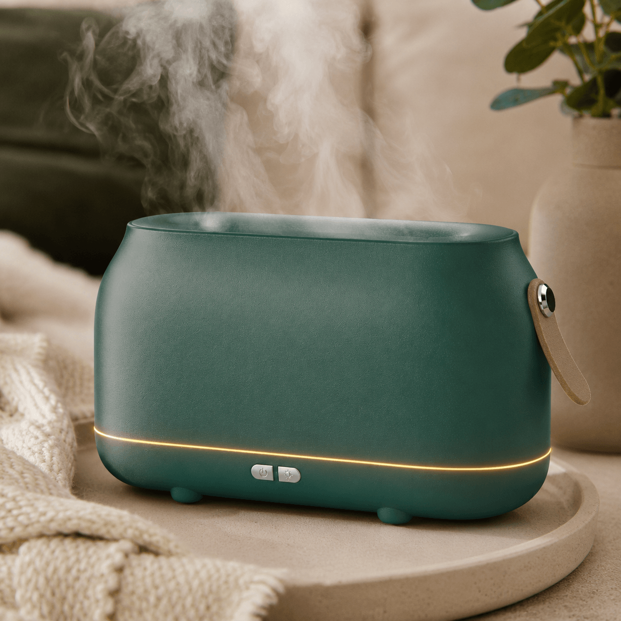 Green flame aroma diffuser with soft mist in a warm bedroom setting.