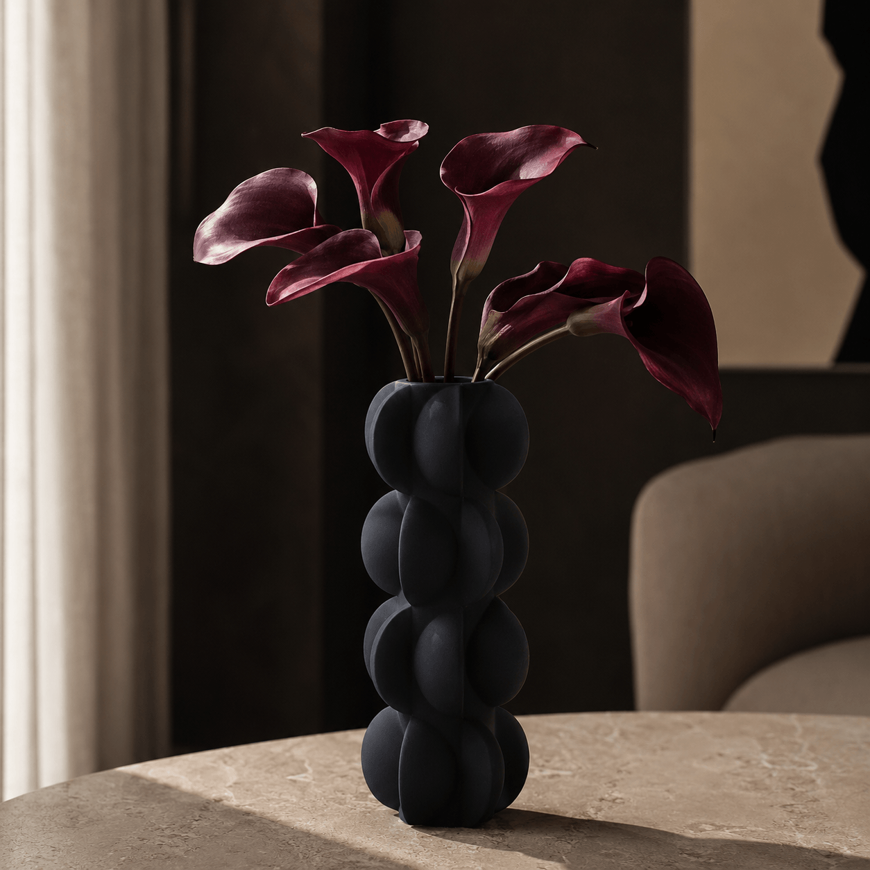 Matte Black Sculptural Bubble Ceramic Vase styled with burgundy calla lilies in a moody modern interior