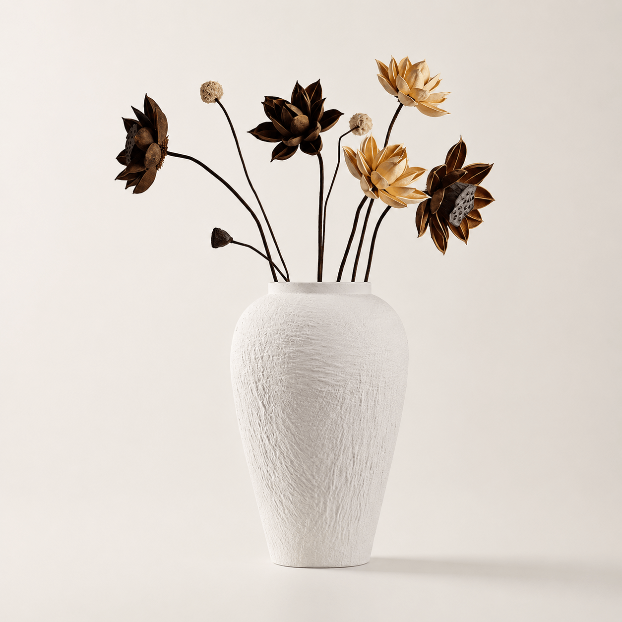 White textured vase styled with delicate branches in soft sunlight