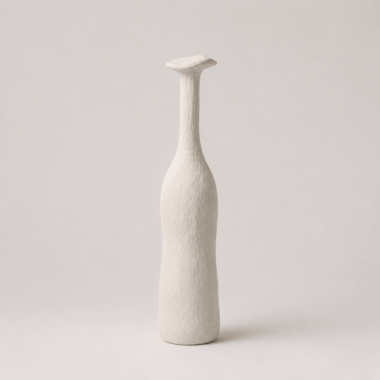 Artistic White narrow-neck ceramic vase on a clean background.