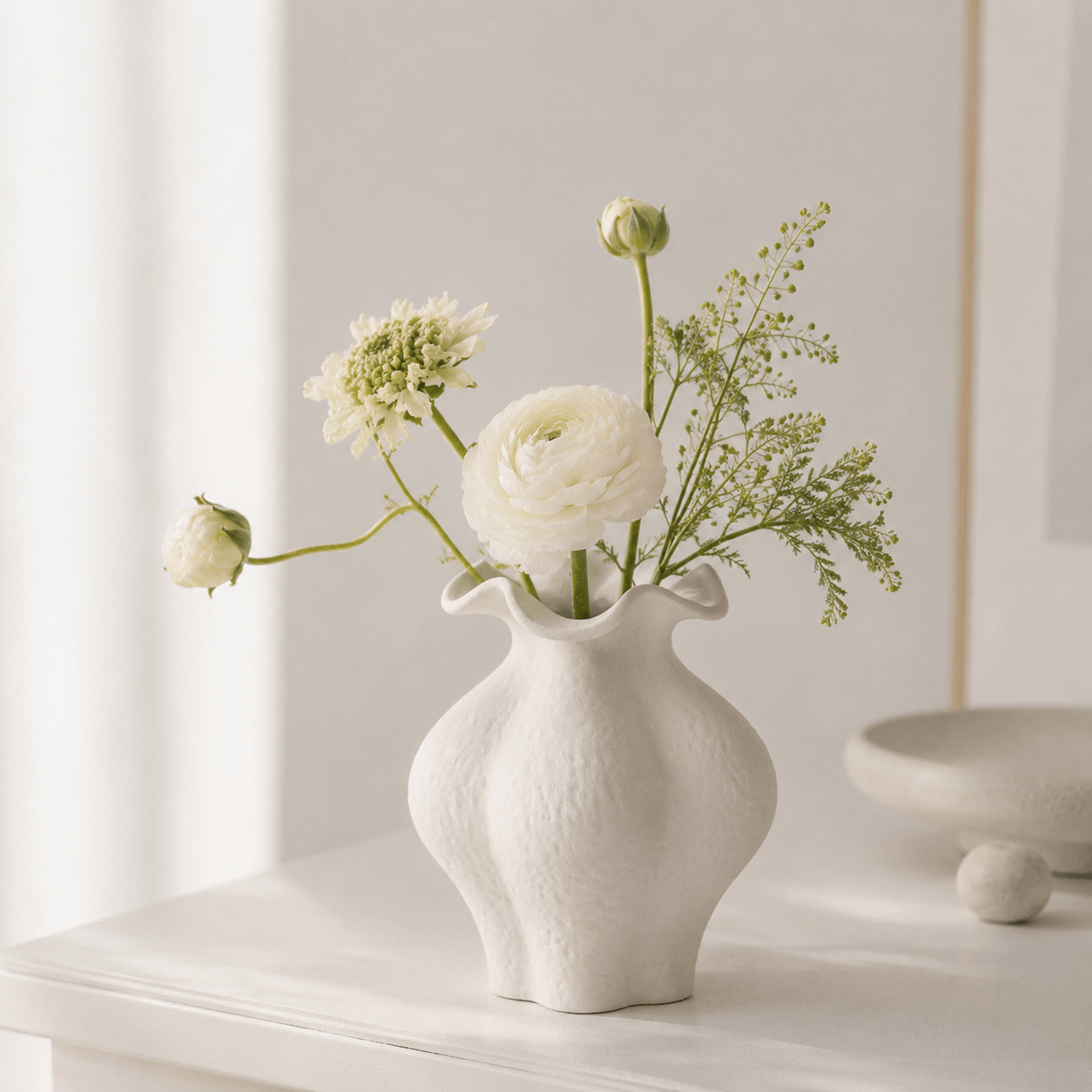 White Small Petal Vase styled with delicate flowers in a bright minimal interior