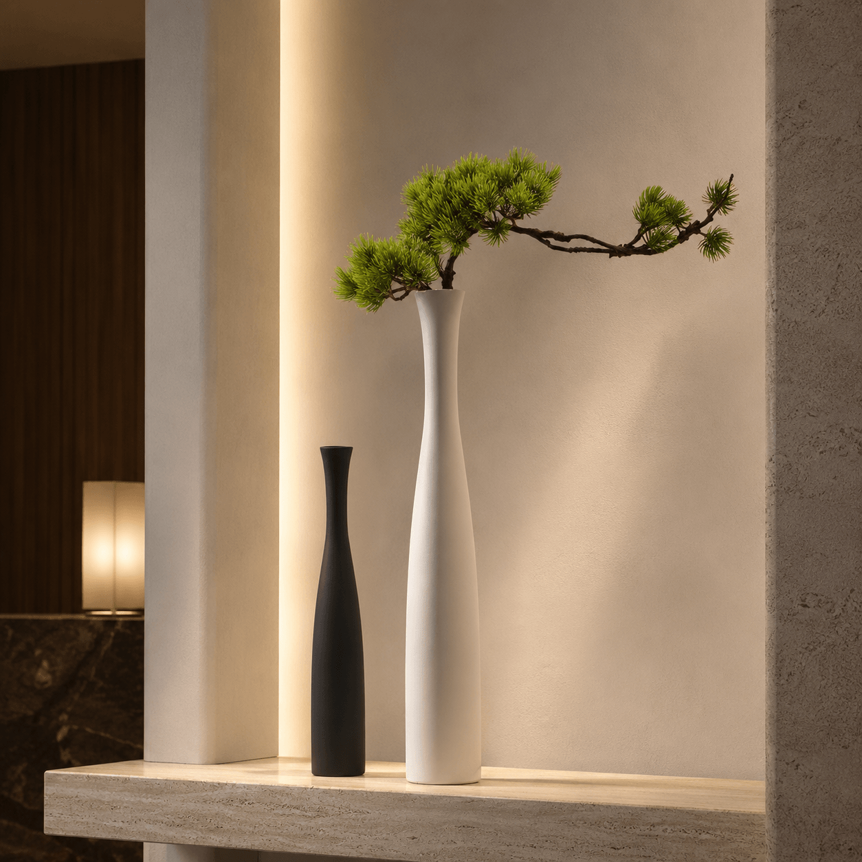 Sculptural black and white ceramic vases styled in a soft-light interior for elegant modern decor.