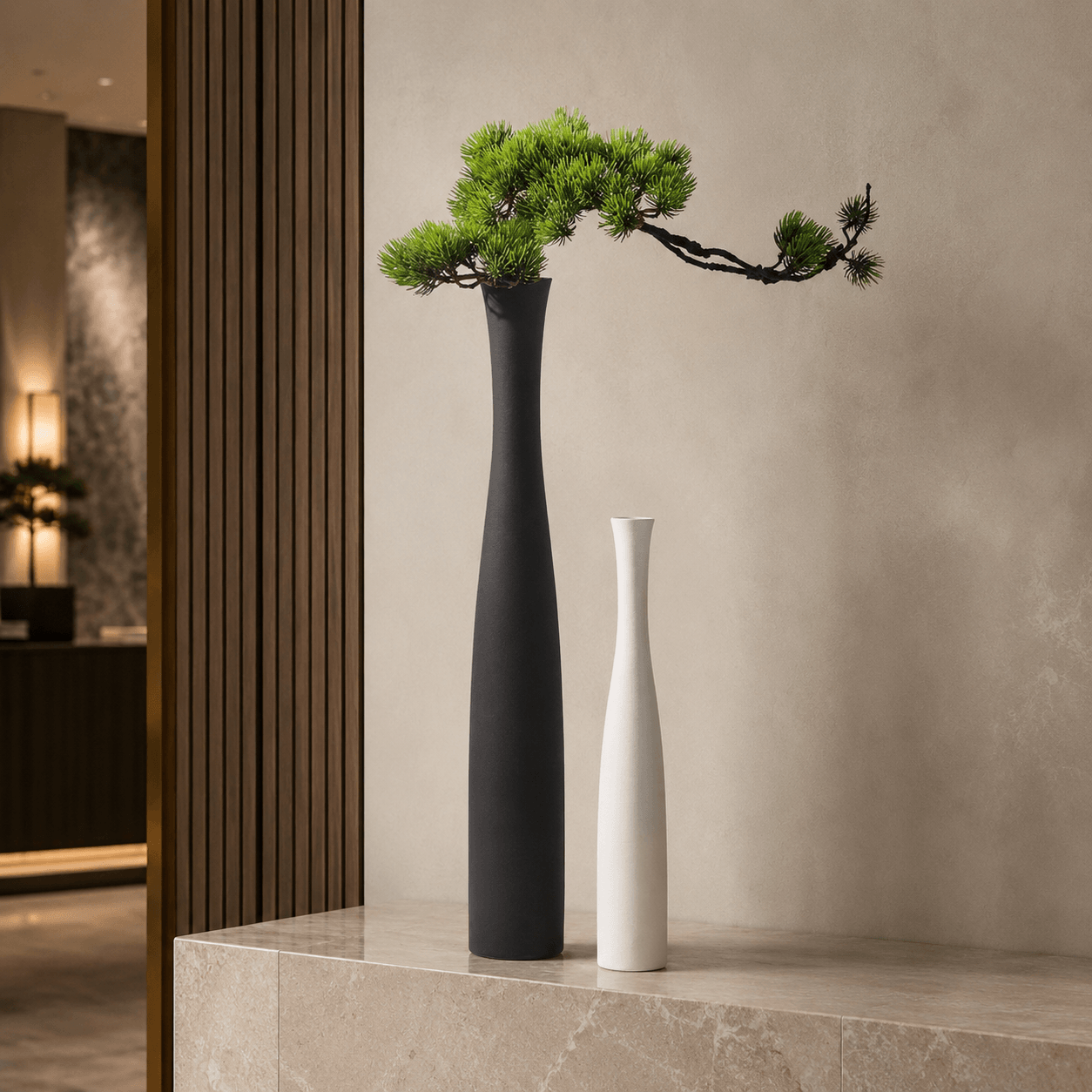 Large white and small black ceramic vases styled on a wood console with soft natural light.