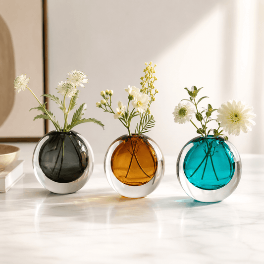Dark Gray, Amber, and Peacock Blue glass vases styled together with fresh flowers.