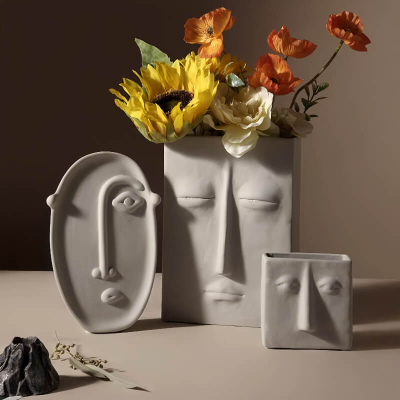 Various face design vases with flower arrangement