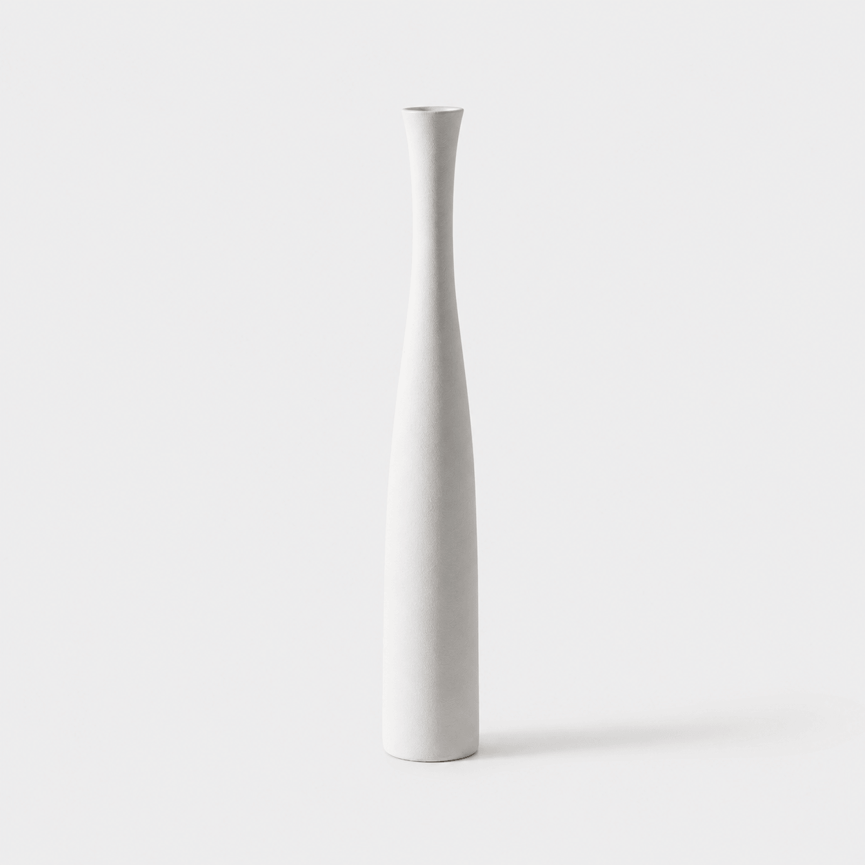 Small pearl white ceramic vase with a clean elongated shape for modern home decor.