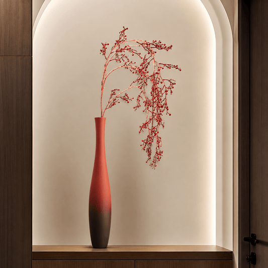 Tall terracotta floor vase styled with red berry branches in a modern arched interior niche.